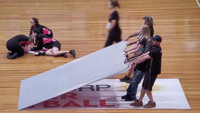 A decal is removed before the controversial abandoned match at Netball SA Stadium. Picture: Twitter