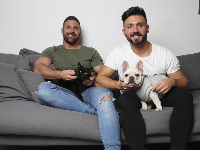 Alfie Arcuri (right) at home with is partner Ash Frenken, their cat Priscilla and dog Gary. Picture: Dylan Robinson