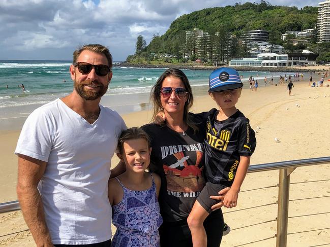 Janneke Leffers with her family at Burleigh beach. Ms Leffers runs a business called ‘Moving to the Gold Coast’.