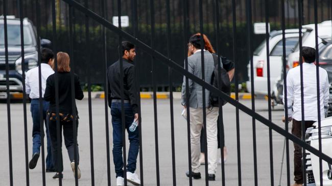 Family members of the victims are escorted through a private carpark at Lidcombe coroner’s court on Tuesday. Picture: NewsWire/Nikki Short