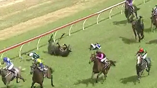 Three jockeys Emily Atkinson (So Super, white and blue silks), Luke Rolls (Cutting Loose, black and blue silks) and Tennille Gray (Baltic Cavalier, white silks) fell off their horses during race one at Clarence River Jockey Club in Grafton on Monday, 29th March, 2021.