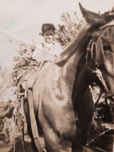 Theo Maras sits on Queenie, circa mid-1950s