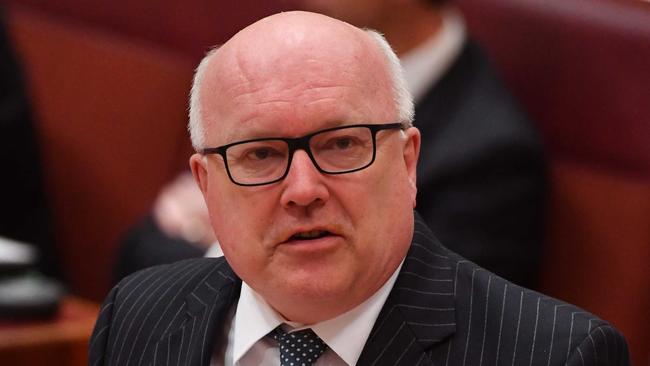 Attorney-General George Brandis called for “less overlap and less double-handling” in family law matters. Picture: AAP/Mick Tsikas