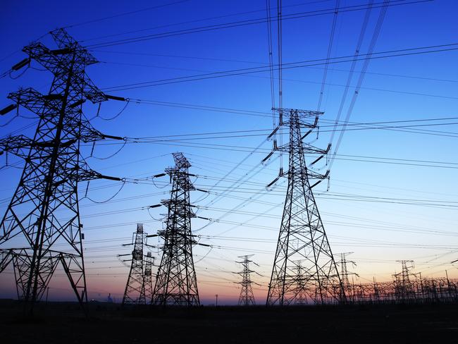 The silhouette of the evening electricity transmission pylon