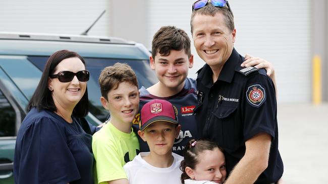 Kathy, Dominic, 14, Marty, 13, Liam, 10, and Charlotte, 7, Hill with their dad Craig Hill at the Queensland Fire and Emergency Services, Brisbane. Craig is part of the team sent from Brisbane to help fight fires in New South Wales. Picture: AAP/Josh Woning