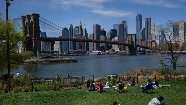 People keep their personal distance as they enjoy a spring afternoon in Brooklyn Bridge Park.