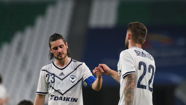 Marco Rojas (left) and Jake Brimmer console each other after Melbourne Victory’s AFC Champions League round-of-16 loss to Ulsan Hyundai. Picture: Simon Holmes/Getty Images