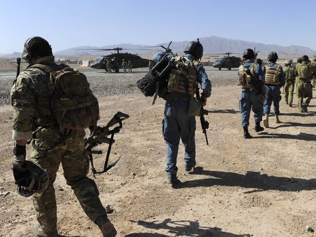 Afghan Officers from the Provincial Police Response Company and Australian Special Operations Task Group Soldiers move towards waiting UH-60 Blackhawk helicopters as part of the Shah Wali Kot Offensive. *** Local Caption *** Afghan National Security Forces (ANSF) partnered with Australian Special Forces from the Special Operations Task Group conducted a deliberate operation to clear a Taliban insurgent stronghold in the Shah Wali Kot region of northern Kandahar province. The Shah Wali Kot Offensive comprised synchronised and deliberate clearance operations involving Australian Commandos combined with a number of surgical helicopter-born assaults from Special Air Service (SAS) troops on key targets. Removing Taliban insurgents from Afghan communities allows the Government of Afghanistan to establish a presence and gain the trust of the community to provide them with necessary infrastructure and security that was not provided by the insurgents. The Shah Wali Kot Offensive was part of Australia’s contribution to Operation Hamkari, the Coalition operation to extend the Government of Afghanistan’s influence into Kandahar City.