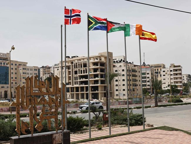 The flags of Norway, South Africa, Palestine, Ireland, and Spain fly at an entrance of Ramallah city in the West Bank. Picture: AFP