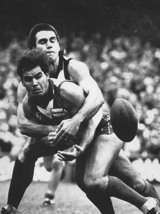 Greg Phillips tackles Greg Williams while playing for Collingwood in 1987.