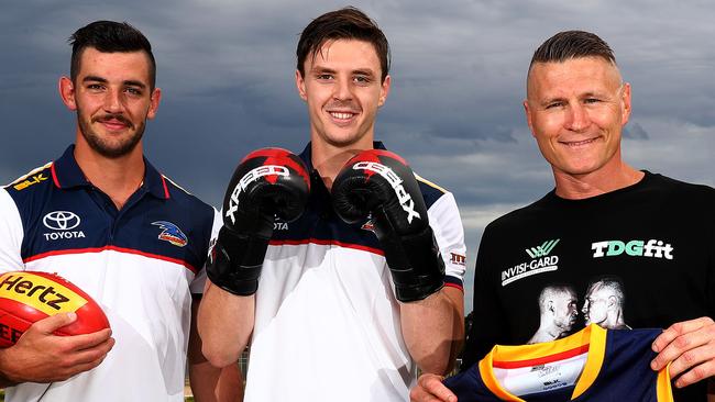 Boxer Danny Green with Taylor Walker and Jake Lever. Picture: Simon Cross