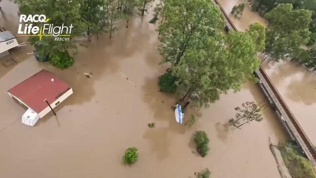 Watch: Stranded family winched from flooded home