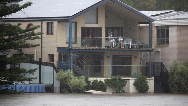 The Van Den Broek family watch the flood levels rise. Picture: Toby Zerna