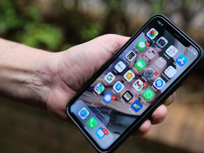 SYDNEY, AUSTRALIA - Newswire Photos - September 27, 2022:A general view of a man holding a smart phone in the wake of the Optus scandal. Picture: NCA Newswire/ Gaye Gerard