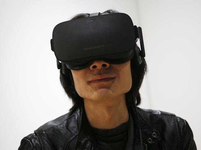 Peijun Guo wears the Oculus Rift VR headset at the Oculus booth at CES International, Wednesday, Jan. 6, 2016, in Las Vegas. (AP Photo/John Locher)