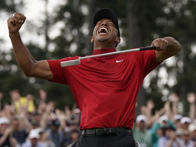 FILE - In this April 14, 2019, file photo, Tiger Woods reacts as he wins the Masters golf tournament at Augusta National in Augusta, Ga. It was voted the third best Masters. Woods blazing to victory in his Sunday red at the Masters, a scene once so familiar, was never more stunning.  (AP Photo/David J. Phillip, File)