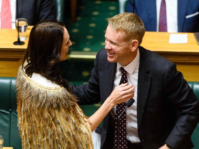 Outgoing New Zealand prime minister Jacinda Ardern hugs Zealand Prime Minister Chris Hipkins during her valedictory speech in parliament in Wellington on April 5, 2023. (Photo by Mark Coote / AFP)