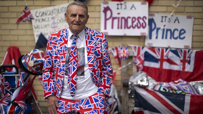 Royal fan Terry Hutt, aged 79, with his Union flag designed outfit, flags and signs stands across the street from the Lindo Wing of St. Mary's Hospital in London, Thursday, April 23, 2015. Britain's Kate the Duchess of Cambridge is expected to give birth to her second child with her husband Prince William at the hospital in the coming days or weeks. A small number of dedicated royal fans are waiting or camping outside the hospital awaiting the imminent birth. (AP Photo/Matt Dunham)