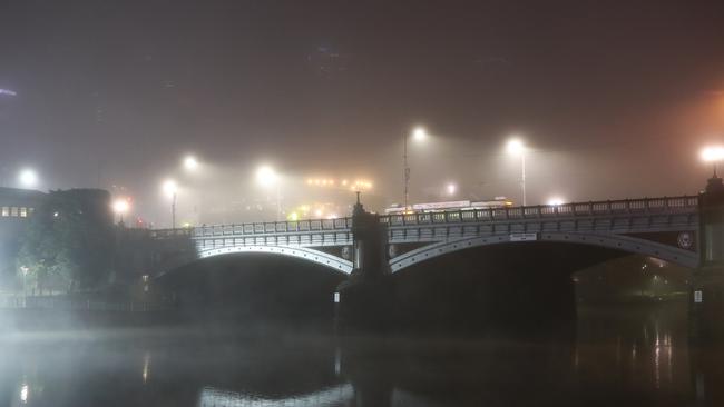 The skyline disappears behind Princes Bridge. Picture: David Crosling