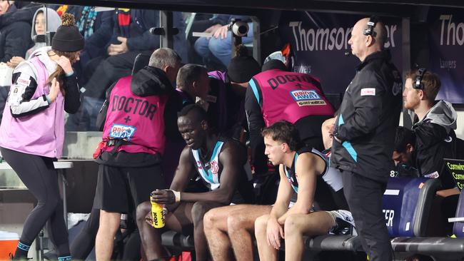 Aliir Aliir sits on the bench. Picture: Sarah Reed/AFL Photos via Getty