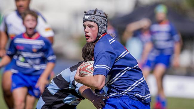Day One of King of the Country rugby tournament at James Overell Park, Southport. Maroochydore Swans U14s' ( big stripes - blue) in action against USQ Saints U14s' (darker blue small stripes). USQ Saints U14's Fraser Coleborn . Picture: Jerad Williams