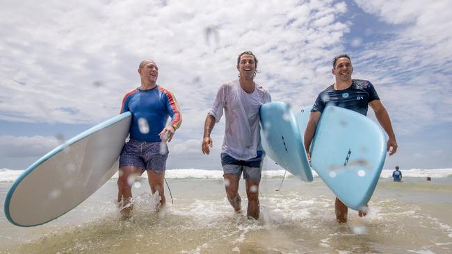 It was all fun in the surf as Nacho Figueras and Billy Slater got competitive in the water. Picture: Luke Marsden