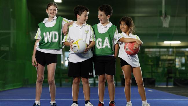 Olds Park Phoenix Netball Club players Casey English, Cooper and Mason Roberts and Ashton Matthews all aged 10 show one of the popular reasons why locals love Peakhurst Heights. Picture: Jonathan Ng