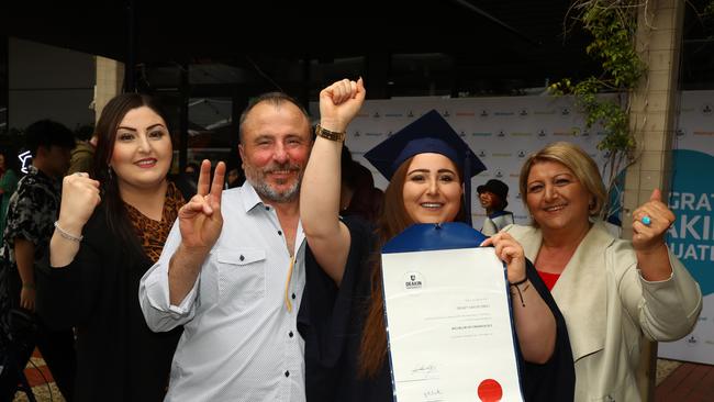 Graduate Demet Mavis Isikli with sister Dilek dad Necati and mum Neriman at the Deakin University Graduation post ceremony celebration. Picture: Alison Wynd