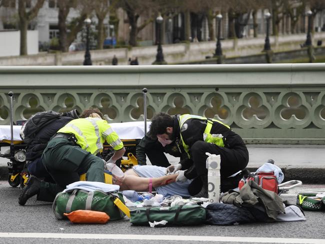 Paramedics treat an injured person after an incident on Westminster Bridge in London. Picture: Toby Melville