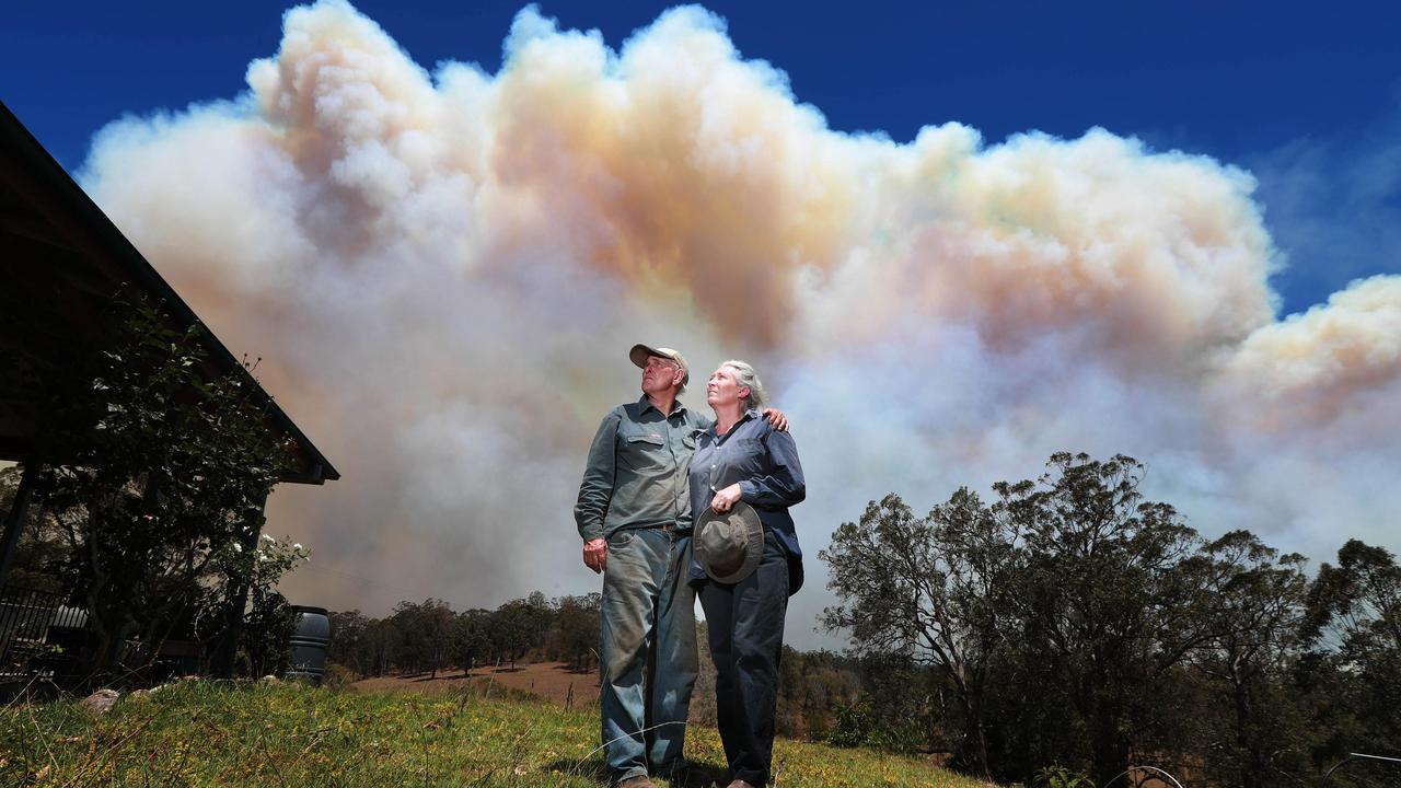 Smoke billows around Hillville as Barry and Shellie Smith prepare for the worst on Tuesday. Picture: Gary Ramage