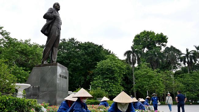 Workers arrange flower pots at the monument to Soviet founder Vladimir Lenin in Hanoi ahead of the Putin visit. Picture: AFP