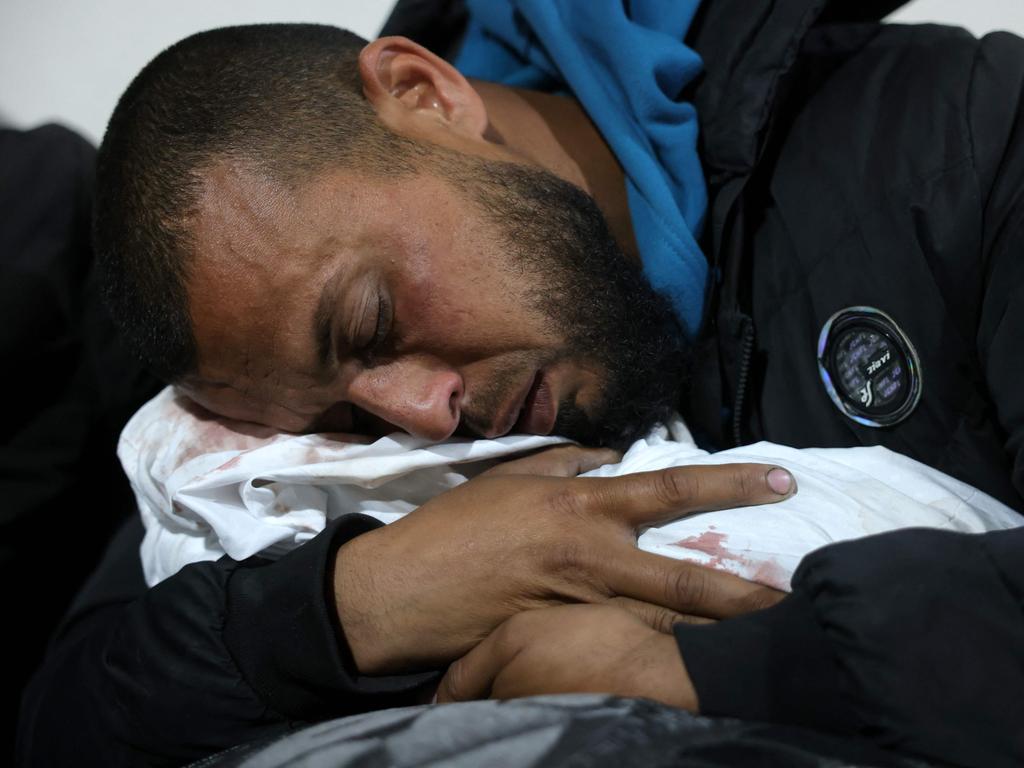 A Palestinian man hugs the body of a baby following Israeli overnight airstrikes in the northern Gaza Strip, at the Indonesian Hospital in Beit Lahia, on March 20, 2025. Picture: Bashar Taleb/AFP