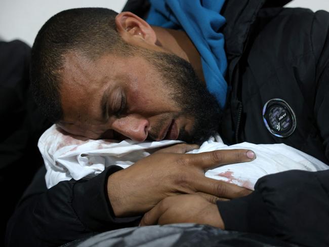A Palestinian man hugs the body of a baby following Israeli overnight airstrikes in the northern Gaza Strip, at the Indonesian Hospital in Beit Lahia, on March 20, 2025. Picture: Bashar Taleb/AFP