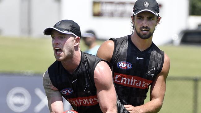 Josh Daicos tackles Tom Mitchell, who has slotted in effortlessly at Collingwood. Picture: Andrew Henshaw