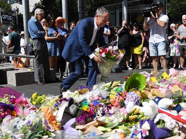 Opposition Leader Bill Shorten lays flowers on the corner of Bourke and Elizabeth streets. Picture: AAP/Tracey Nearmy