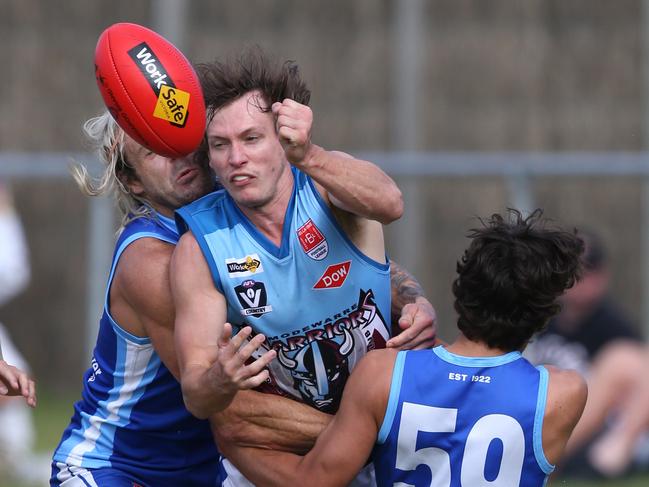 VBFL: Barwon Heads v Modewarre. Modewarre's Matty McKim well held by Barwon Heads Matthew Dyer and Luca Vella. Picture: Mike Dugdale