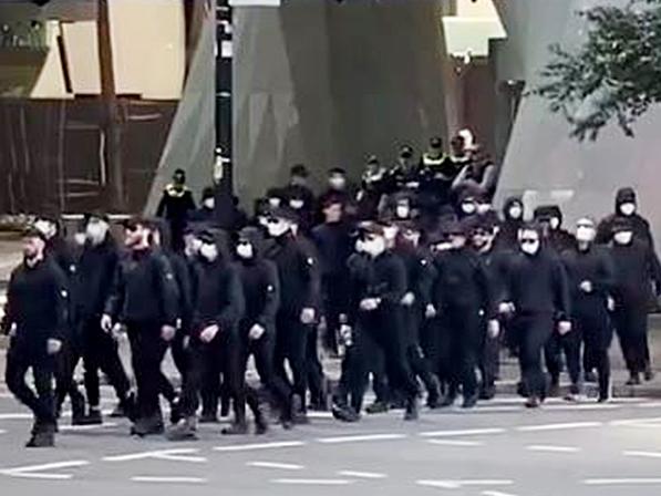 Members of the National Socialist Network march through the Brisbane CBD.