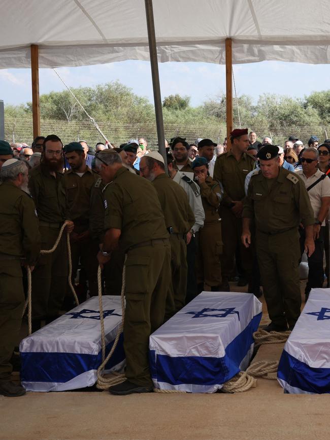 People mourn by the coffins of five members of the Kutz family who were killed in the Hamas attack. Picture: Oren ZIV / AFP