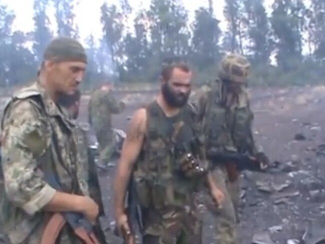 Rebels inspect the scene of the crash.