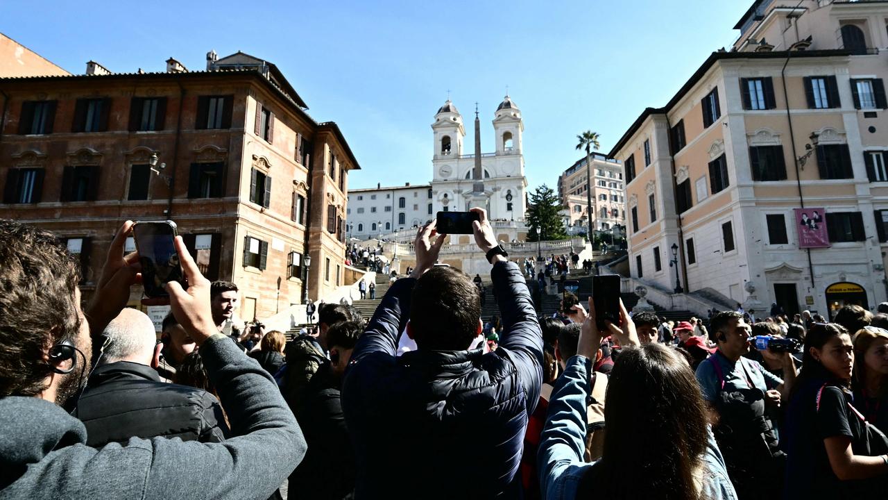 Crowds of tourists take pictures of the Spanish Steps and the church of Trinita dei Monti on March 21 in Rome. Picture: Alberto Pizzoli / AFP