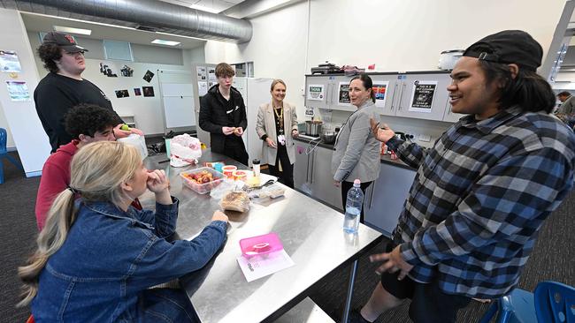 Kylie Spann, head of department and principal Kristie de Brenni, prepare food with students and talk about how the school got them back onto the right track, at the Coorparoo campus, in Brisbane. Picture: Lyndon Mechielsen/The Australian