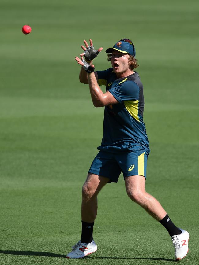 Australia's Will Pucovski catches the ball during a practice session at the Gabba. Picture: AFP