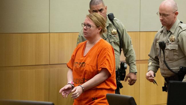 Lisa Cunningham is escorted back to a holding cell by Maricopa County Sherriff's officers in 2018. Picture: Caitlin O'Hara