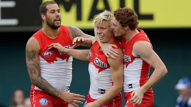 Lance Franklin, Isaac Heeney and Gary Rohan celebrate a Sydney goal.