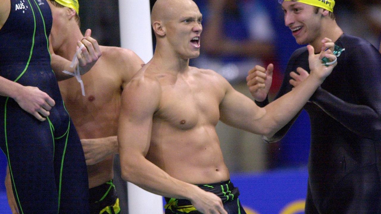 Michael Klim of Australia plays the air guitar after breaking the Men's 4x100 Freestyle Relay World Record