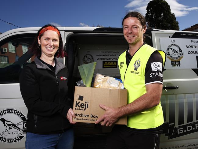 Manager of the West Moonah community house Mel Knuckey and Glenorchy Football Club coach Paul Kennedy delivering care packs to the local community during the COVID-19 pandemic. Picture: ZAK SIMMONDS