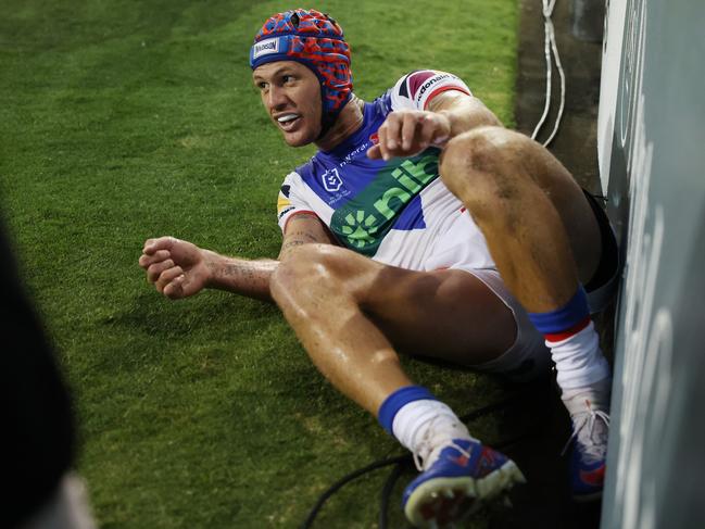 Kalyn Ponga of the Knights hits the fence after tapping the ball into touch. Picture: Getty Images