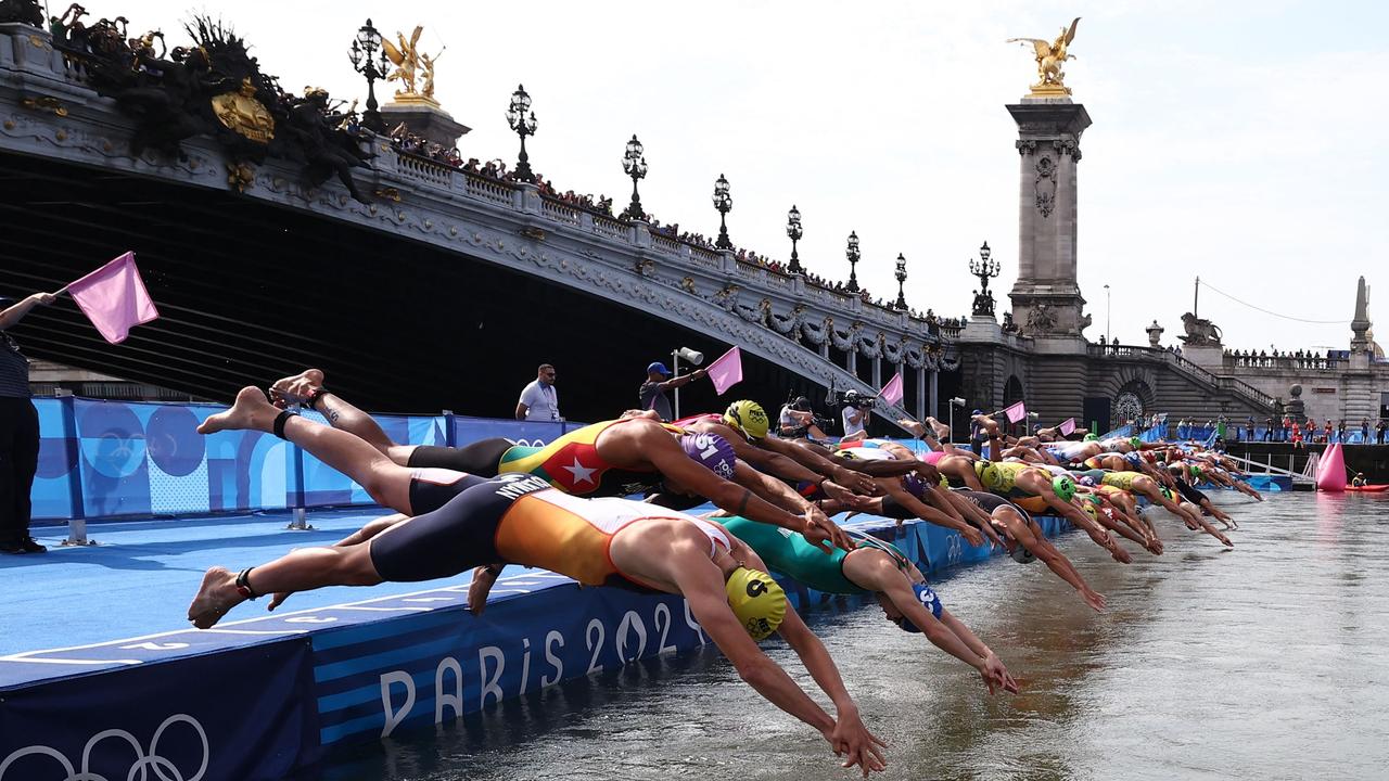 Athletes dive into the Seine river at the start of the men's individual triathlon on July 31, but questions have been asked about the water testing and assessment. Picture: Anne-Christine Poujoulat/AFP