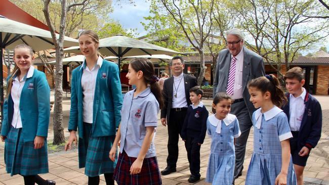 Parramatta Bishop, Vincent Long Van Nguyen and Catholic Education executive Greg Whitby at the site of the new Westmead mega school. L to R: Monique Turner, Aimee Hassett, Ella Baini, Jesse Hekeik, Sienna Mardini, Alessia Mardini and Christian Mardini.