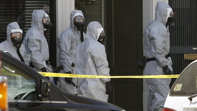 In this photo taken May 31, 2014, agents in hazardous material suits are seen as the FBI searches a building in San Francisco. A San Francisco social media maven and former political consultant who was wanted on suspicion of possessing explosives has been taken into custody after a three-day manhunt. Federal agents and the San Francisco police said they captured Ryan Kelly Chamberlain II, 42, on Monday, June 2, shortly after announcing that they had found his car near Crissy Field, just south of the Golden Gate Bridge. (AP Photo/San Francisco Chronicle, Michael Short) ORTHERN CALIFORNIA OUT; MANDATORY CREDIT PHOTOG & CHRONICLE; MAGS OUT; NO SALES